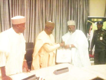 Chairman of NNDC (middle) presenting the NNCMC business plan to Gov. Abubakar Badaru of Jigawa State