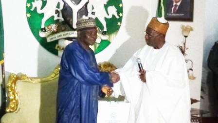 Chairman of NNDC (right) presenting a business plan to Prof. Sonni Tyoden, Deputy Gov. of Plateau State