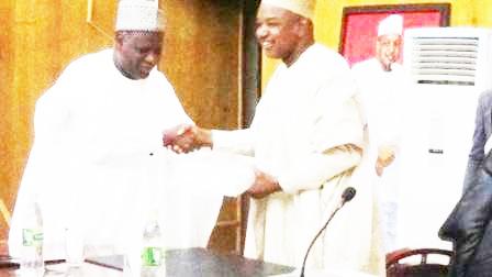 Chairman of NNDC (left) presenting a business plan to Gov. Atiku Bagudu of Kebbi State