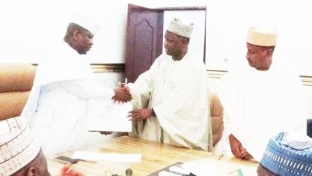 Chairman of NNDC (right) presenting a business plan to Gov. Abdulazeez Yari of Zamfara State