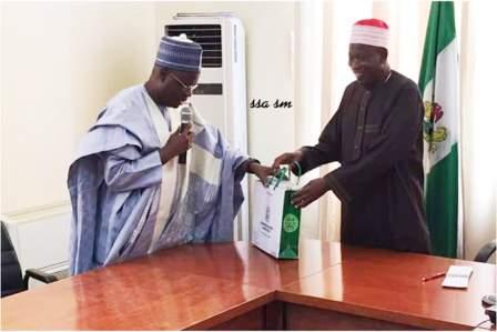 Chairman of NNDC (left) presenting the NNCMC business plan to the Executive Governor of Kano State. Alhaji Abdullahi Ganduje ofr