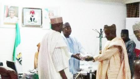 Chairman of NNDC (right) presenting a business plan to Gov. Mohammed Abubakar esq of Bauchi State (middle)